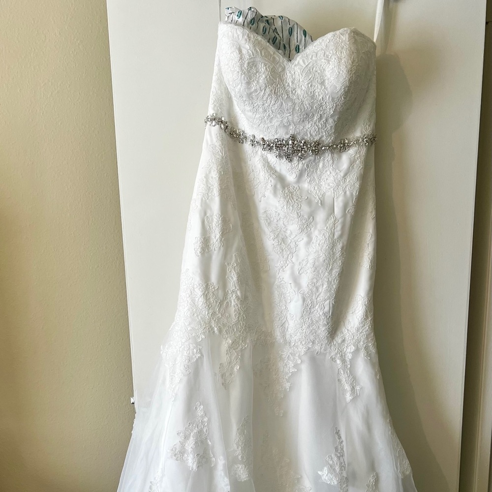 size 16. dry cleaned, put back in storage bag, has veil, bra & slip.